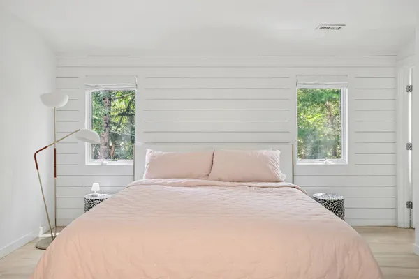 a bedroom with a bed and a window