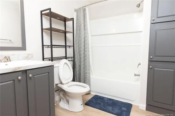 a bathroom with a toilet a sink and a mirror