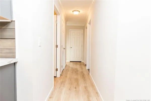 a view of a hallway with wooden floor