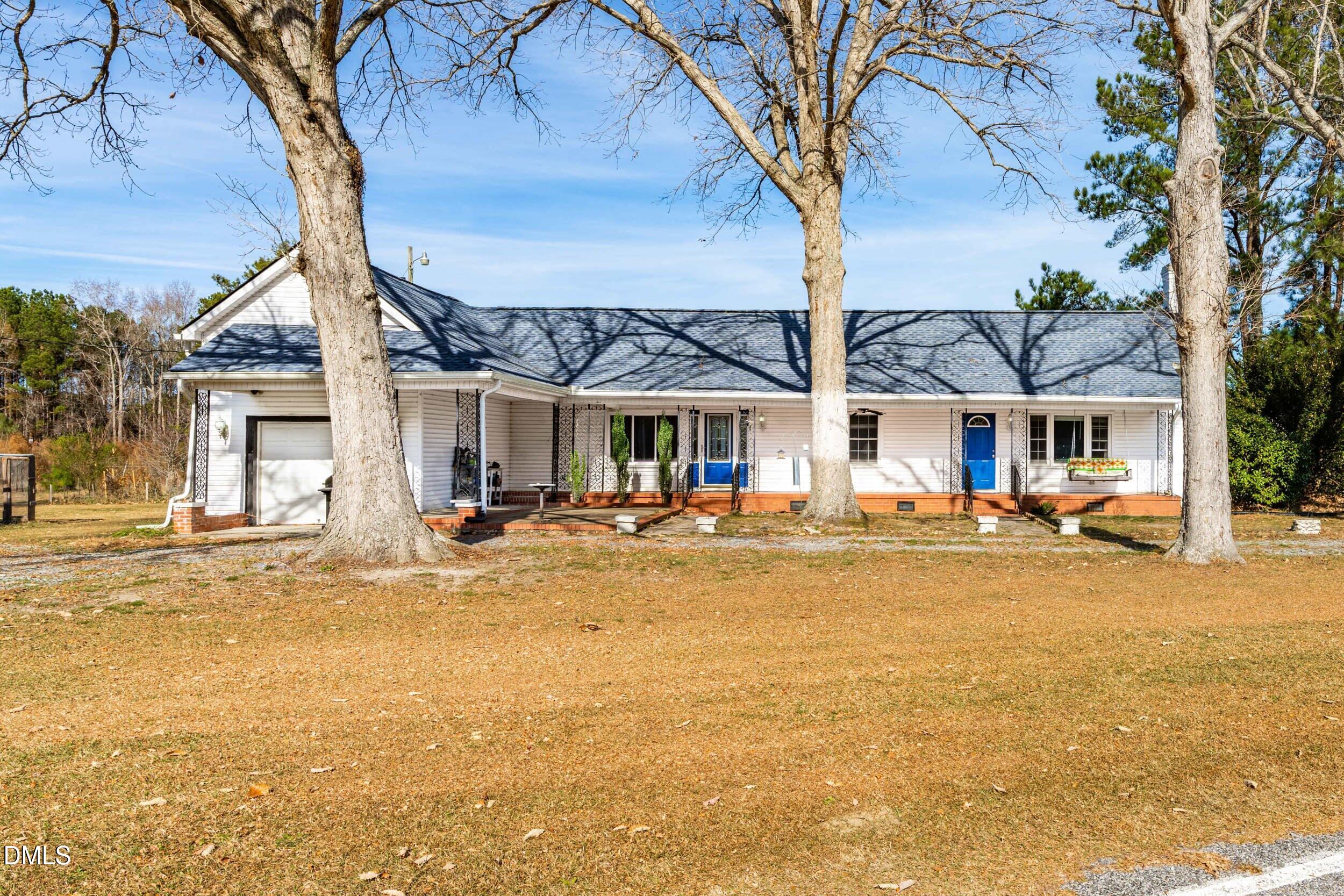 a view of a house with swimming pool and sitting area