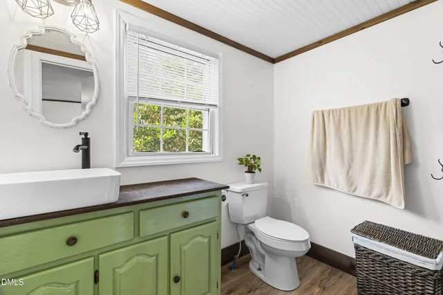 a bathroom with a sink a toilet and window