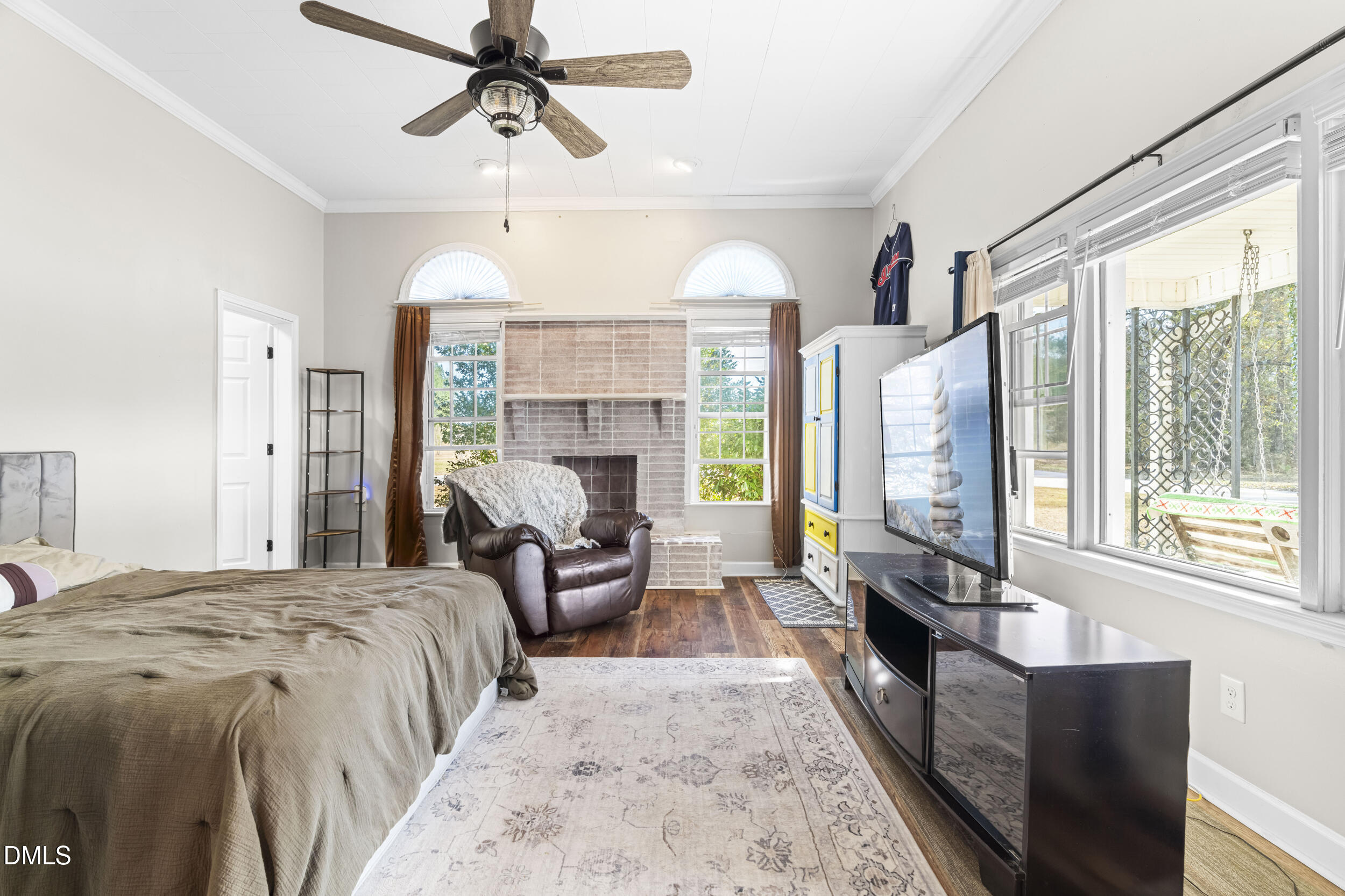215 Old Stancil Road Kenly, NC 27542 - Photo 8 of 21 a spacious bedroom with a balcony a bed and a chandelier