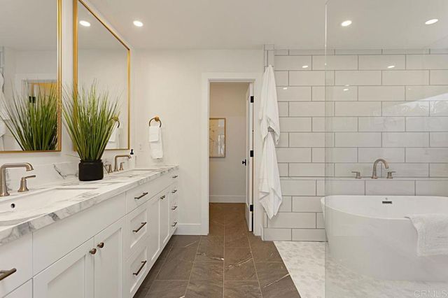 a bathroom with double sink and a mirror