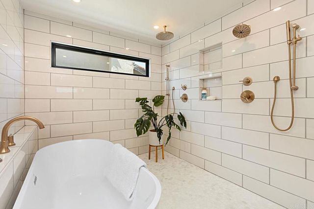 a bathroom with a double vanity sink a mirror and a shower