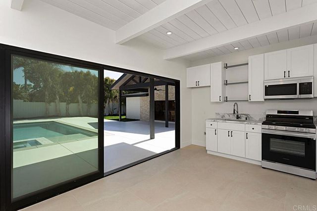 a bathroom with a sink toilet vanity and shower