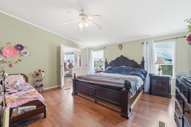 a bedroom with a bed and a chandelier