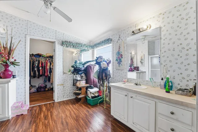 a view of a hallway with closet and wooden floor