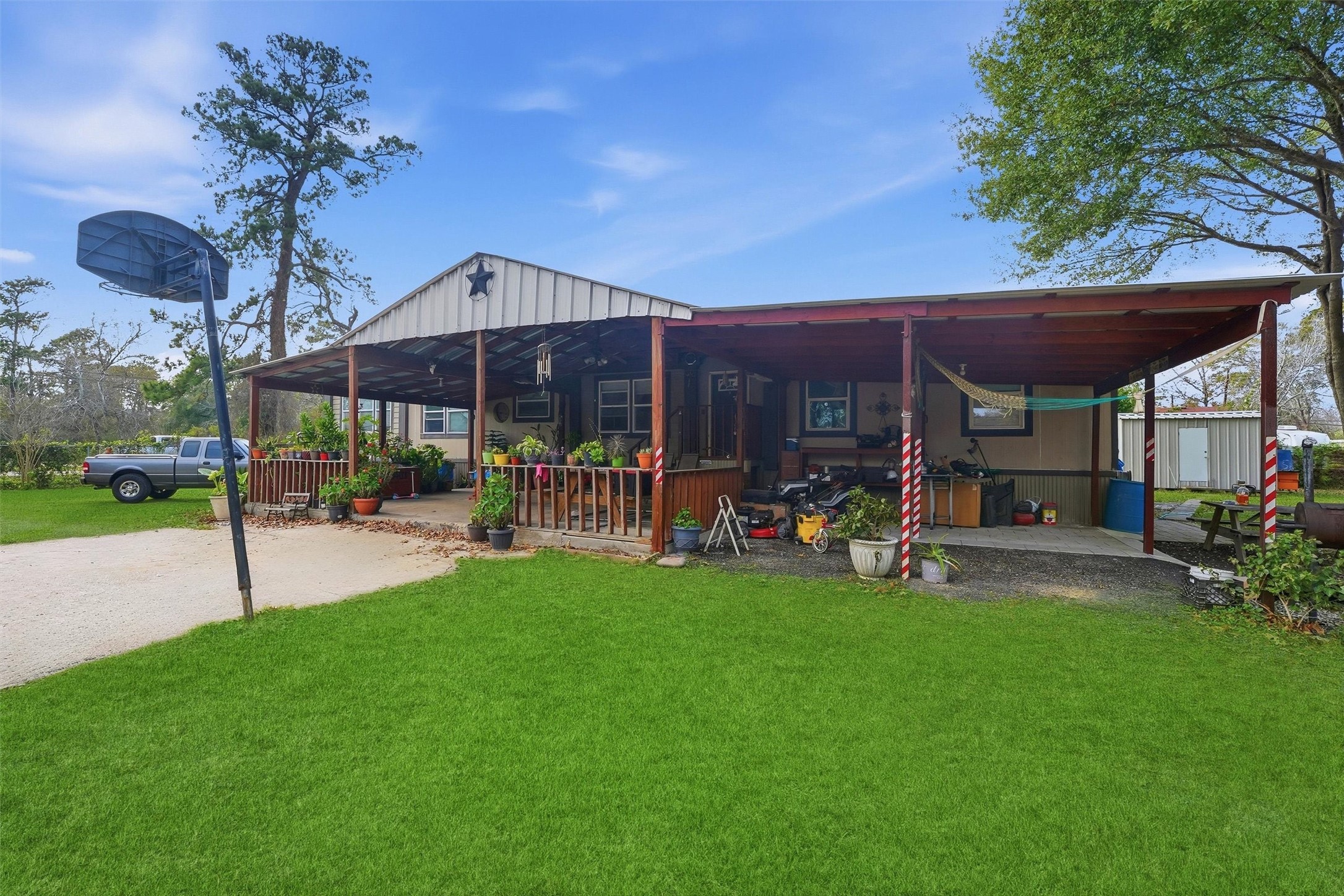 1017 Woodland Street Channelview, TX 77530 - Photo 2 of 25 a view of a patio with table and chairs under an umbrella