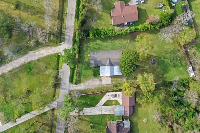 an aerial view of a house with a yard and lake view