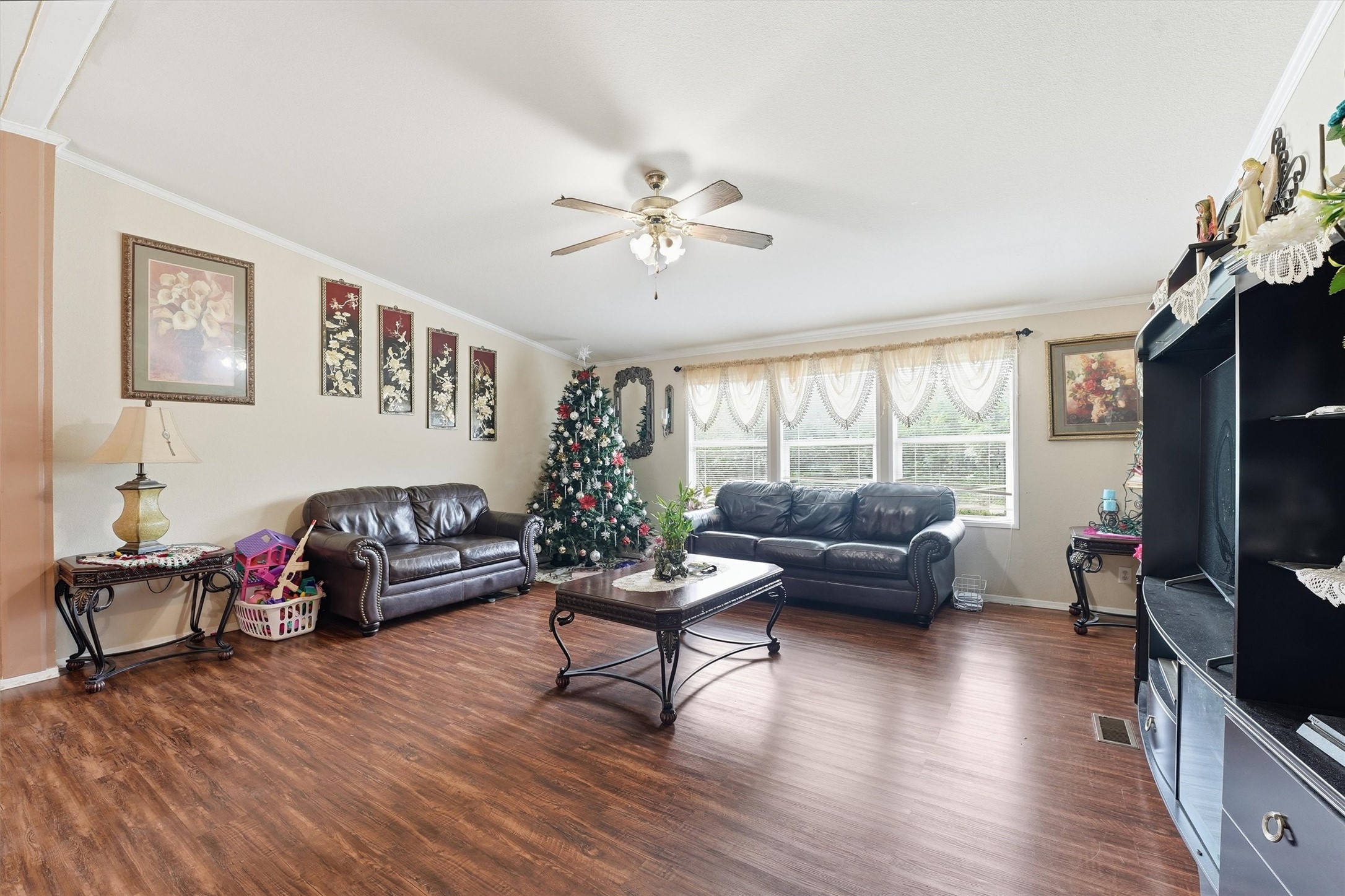 1017 Woodland Street Channelview, TX 77530 - Photo 4 of 25 a living room with furniture flat screen tv and wooden floor