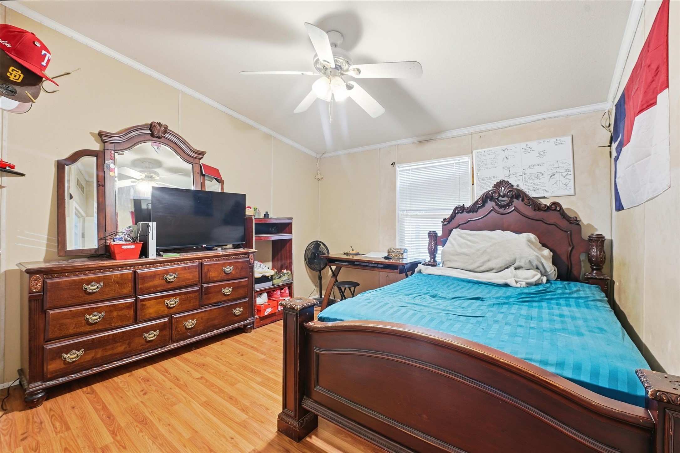 1017 Woodland Street Channelview, TX 77530 - Photo 8 of 25 a bedroom with a bed and a flat tv screen on dresser