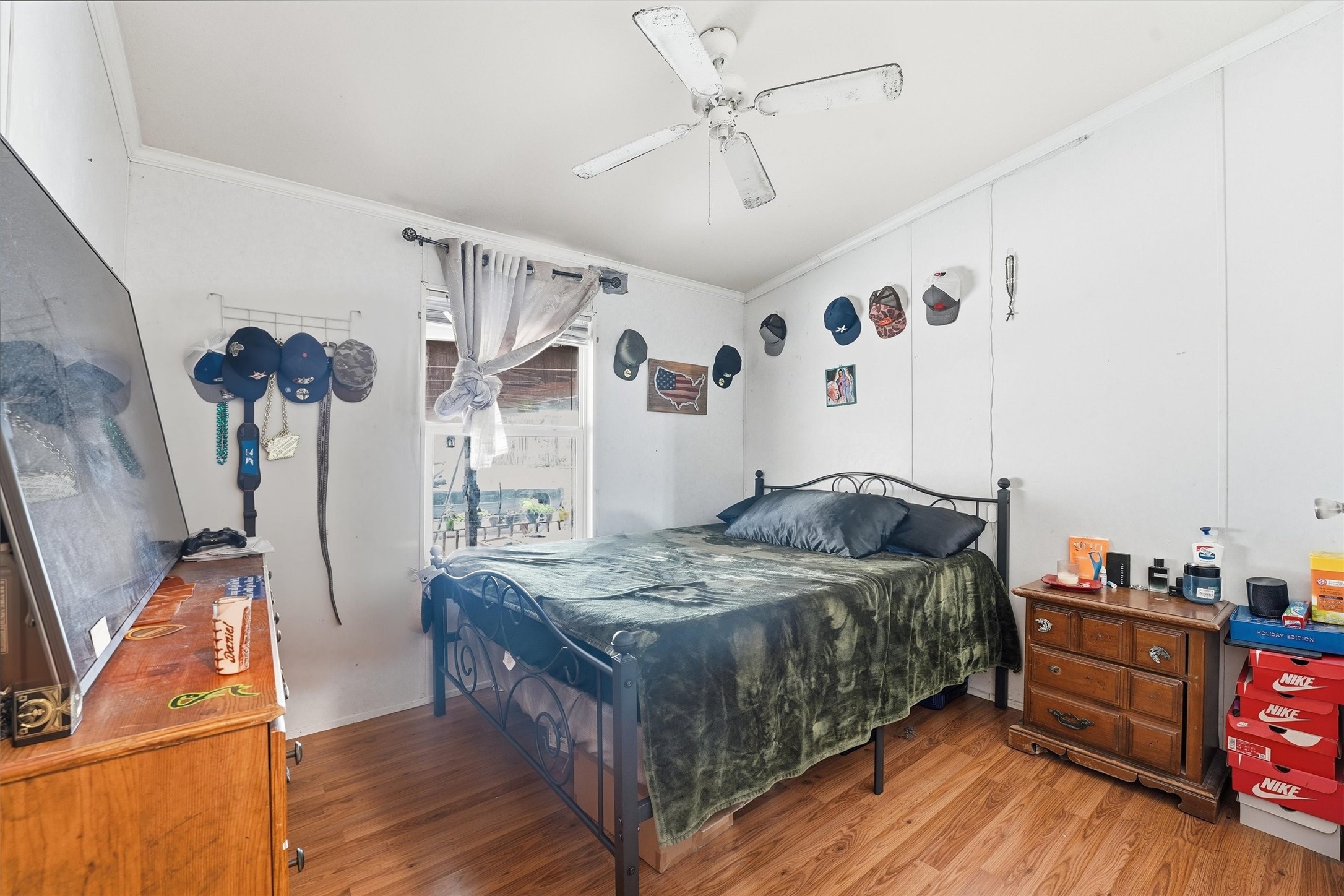 1017 Woodland Street Channelview, TX 77530 - Photo 9 of 25 a bedroom with a bed and wooden floor