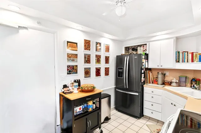 a kitchen with stainless steel appliances a refrigerator and a stove top oven