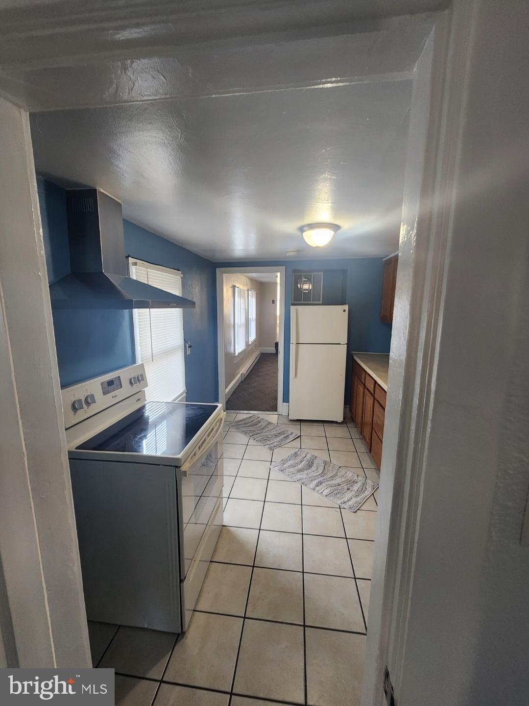 228 East Main Street Elkton, MD 21921 - Photo 15 of 29 a kitchen with a sink a stove top oven and white cabinets