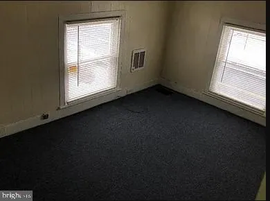 a view of an empty room and a window