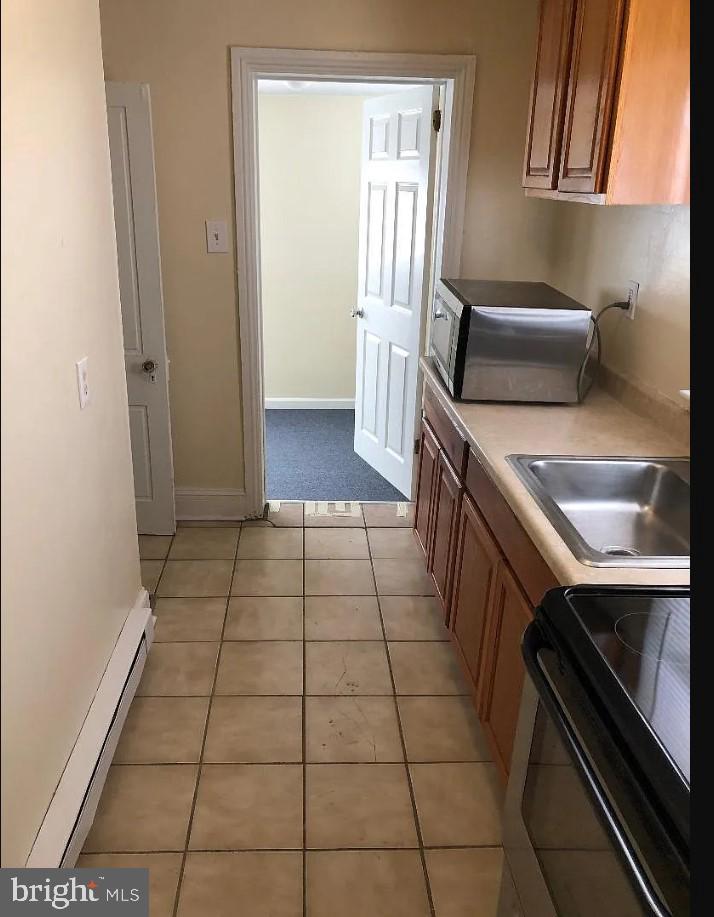 228 East Main Street Elkton, MD 21921 - Photo 5 of 29 a kitchen with a sink a stove and a refrigerator