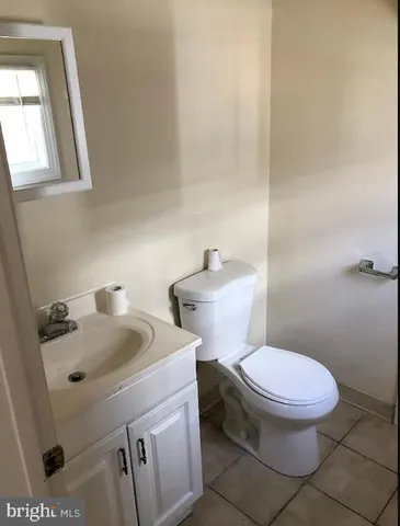 a bathroom with a sink toilet and mirror