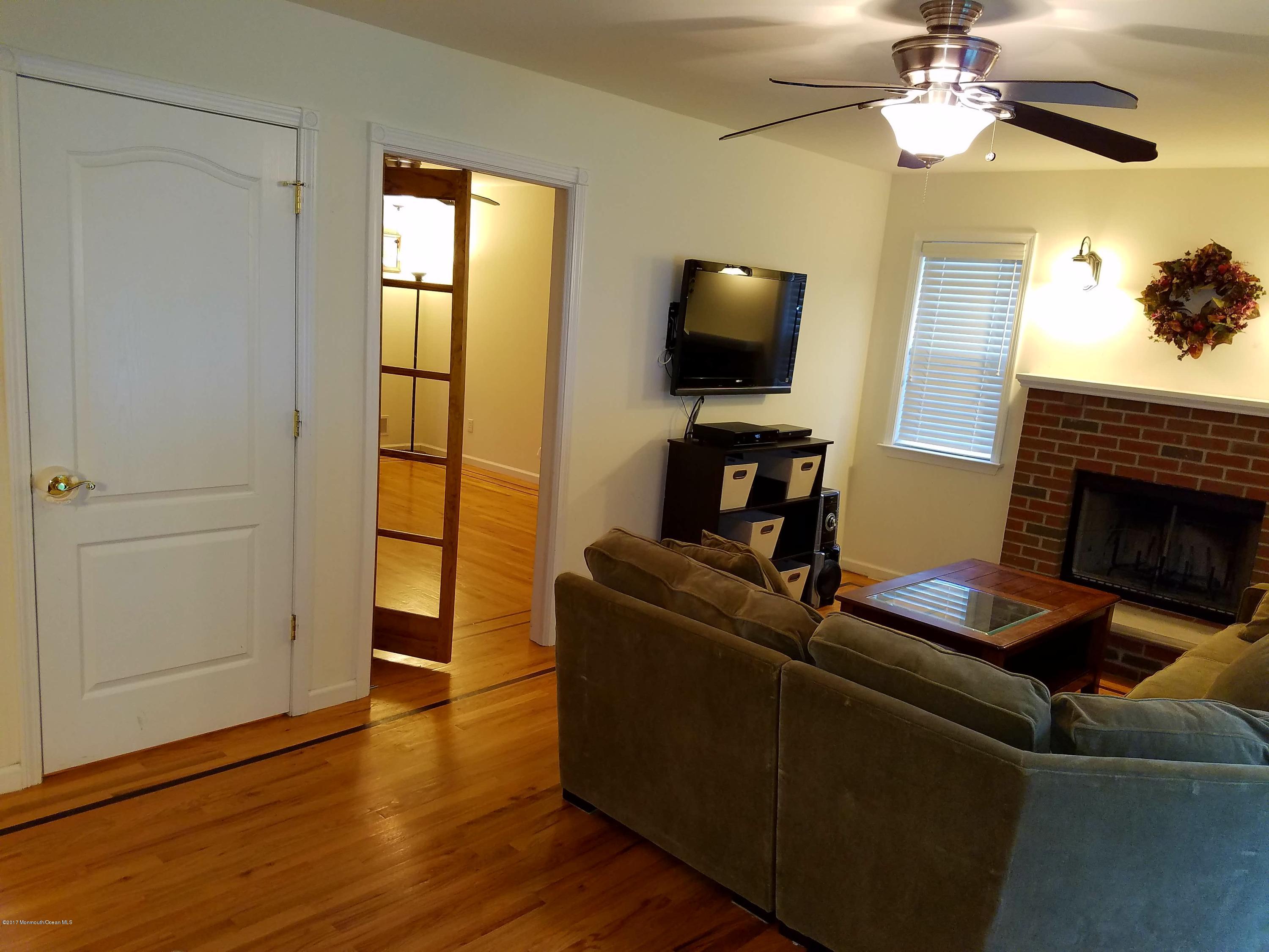 126 Robin Road Neptune Township, NJ 07753 - Photo 12 of 24 a living room with furniture and a flat screen tv