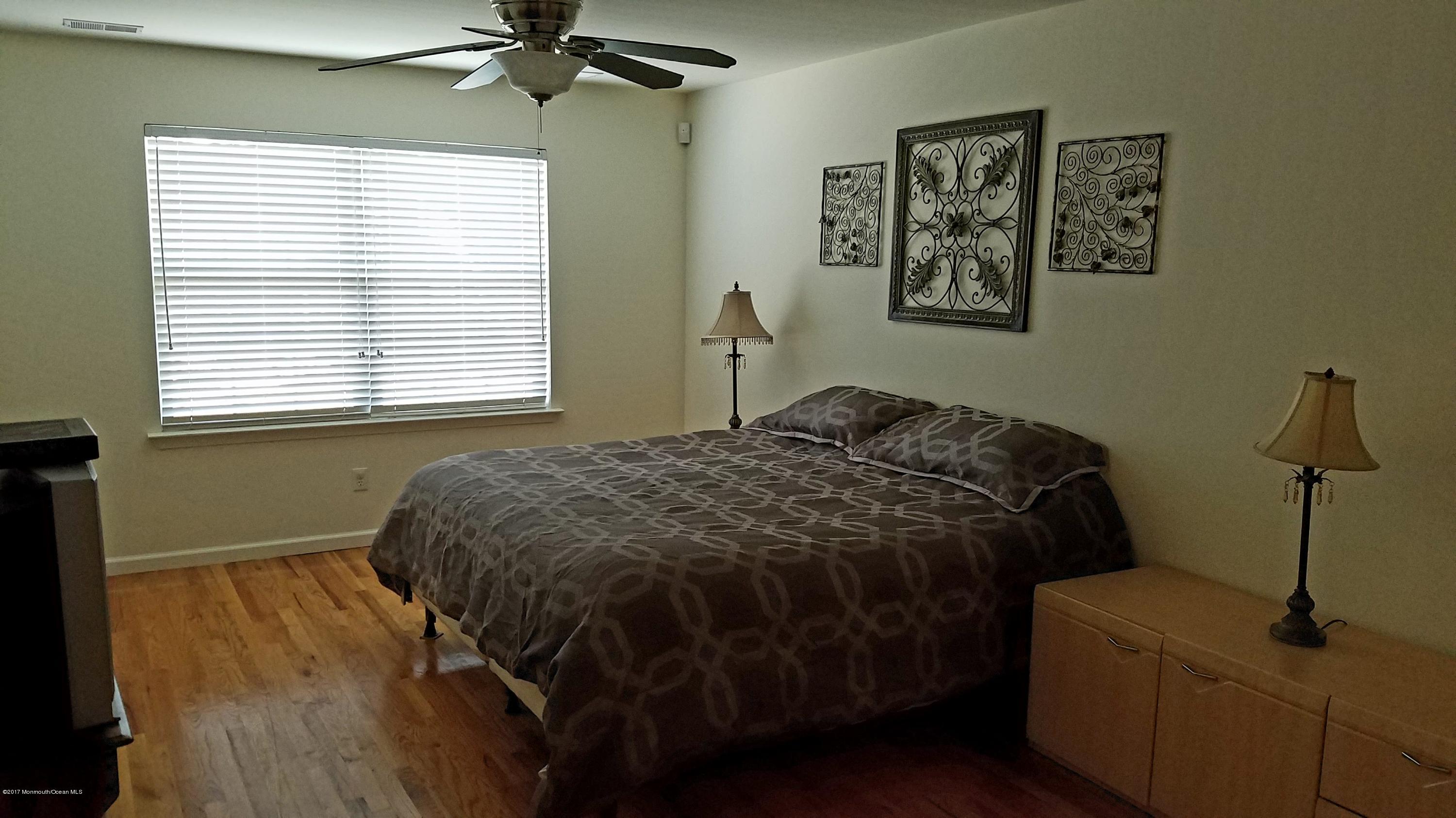 126 Robin Road Neptune Township, NJ 07753 - Photo 14 of 24 a bed sitting in a bedroom next to a window