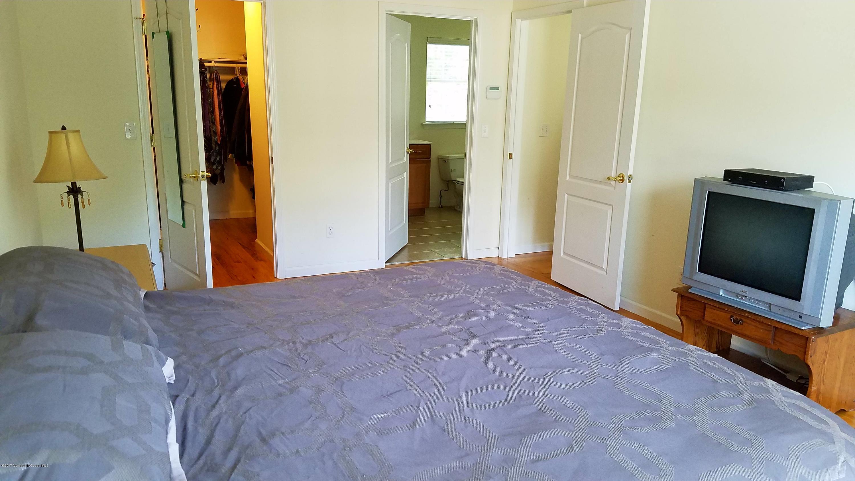 126 Robin Road Neptune Township, NJ 07753 - Photo 15 of 24 a bedroom with a bed and a flat screen tv