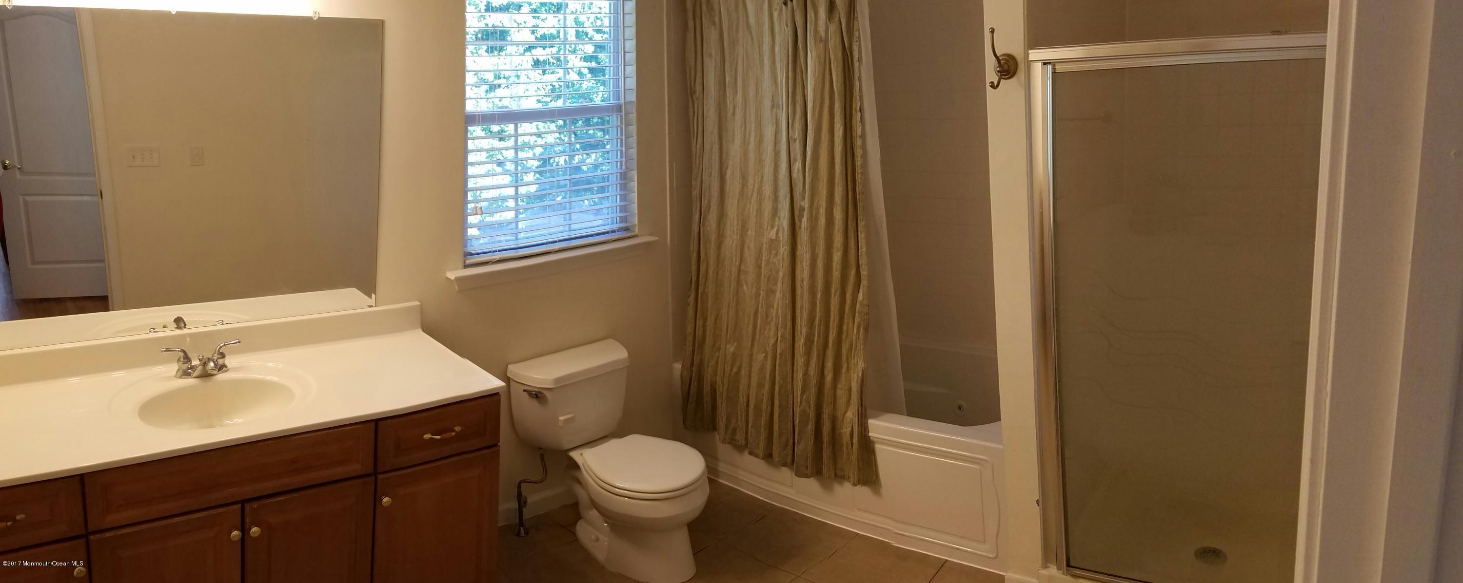 126 Robin Road Neptune Township, NJ 07753 - Photo 16 of 24 a bathroom with a sink a toilet and shower