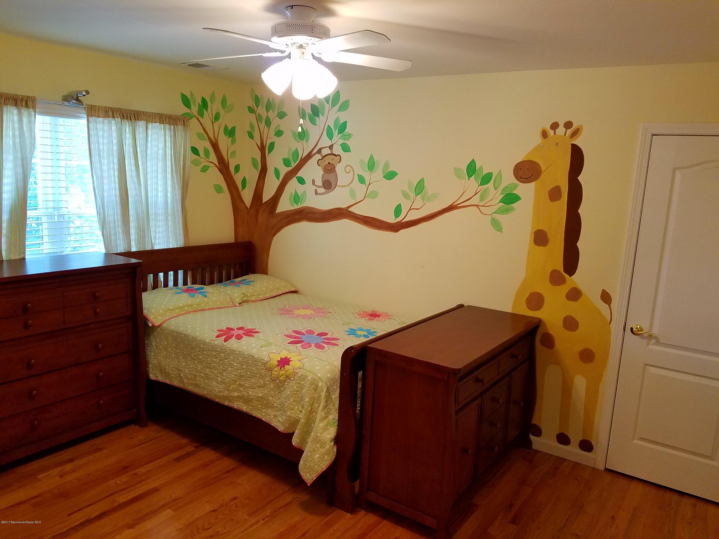 126 Robin Road Neptune Township, NJ 07753 - Photo 17 of 24 a bedroom with a bed and a chandelier