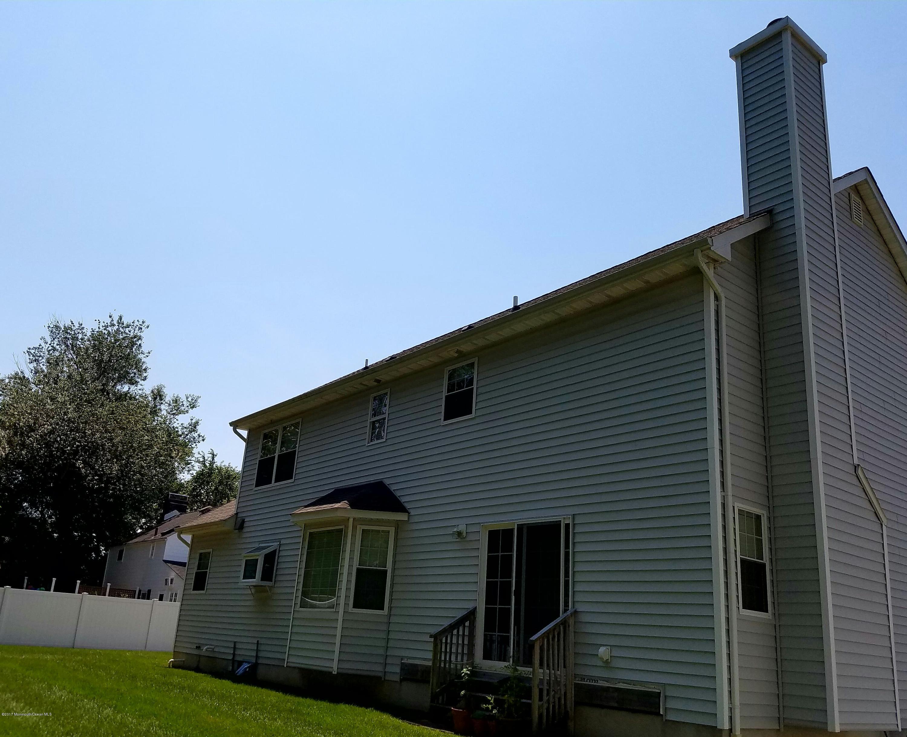 126 Robin Road Neptune Township, NJ 07753 - Photo 24 of 24 a front view of a house with a garden