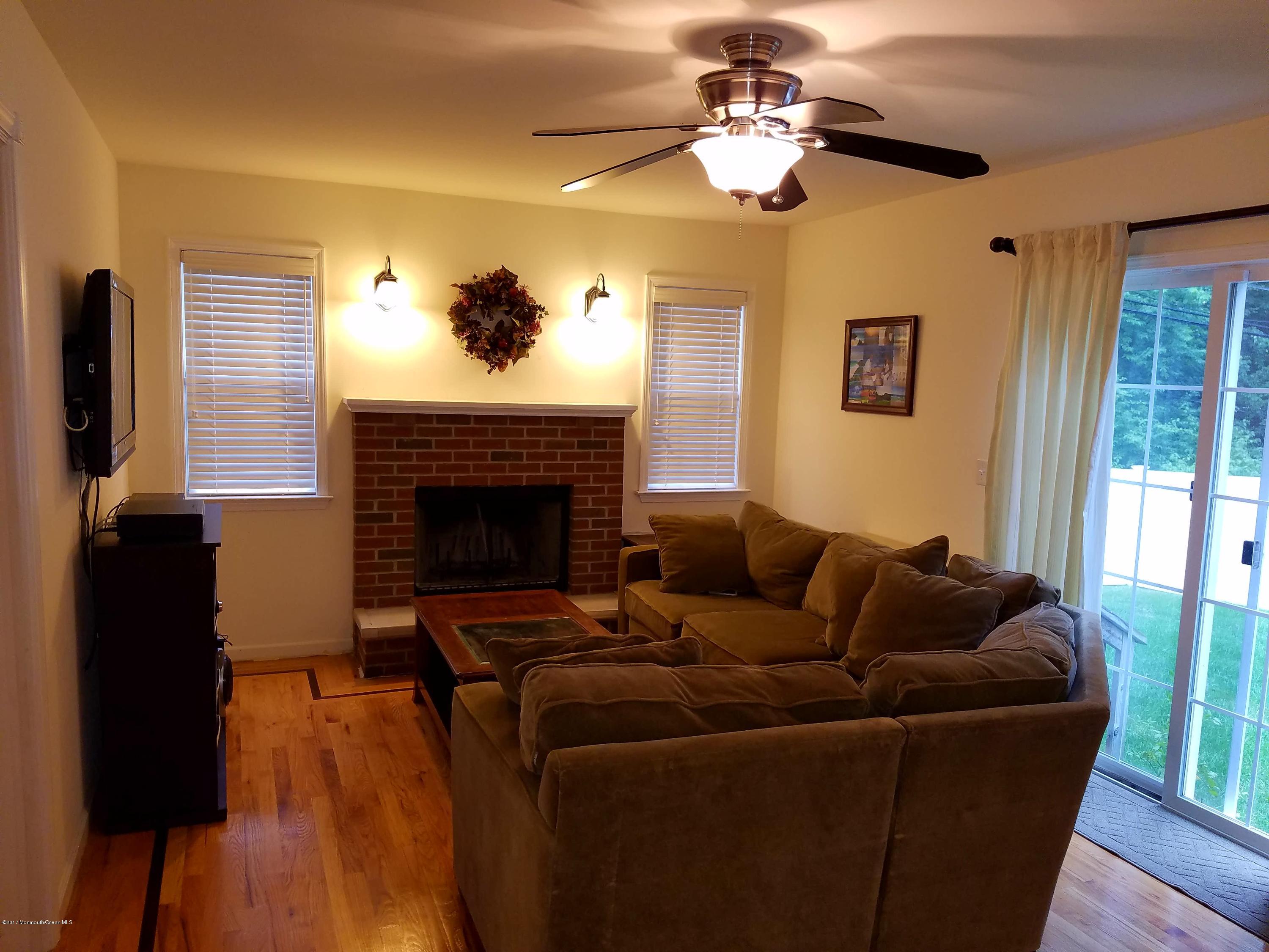 126 Robin Road Neptune Township, NJ 07753 - Photo 4 of 24 a living room with furniture and a fireplace
