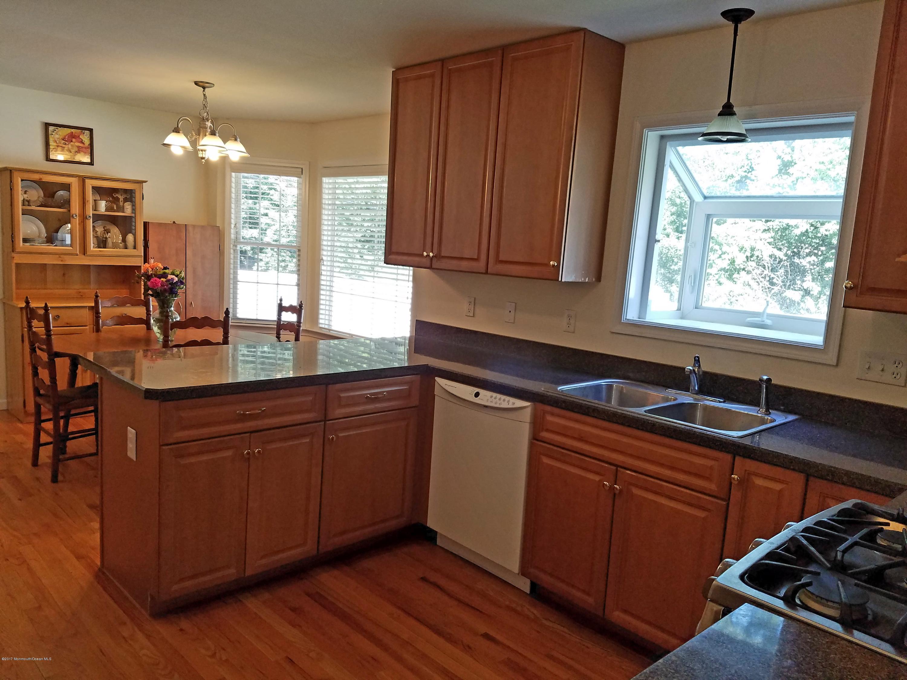 126 Robin Road Neptune Township, NJ 07753 - Photo 7 of 24 a kitchen with wooden cabinets and a sink