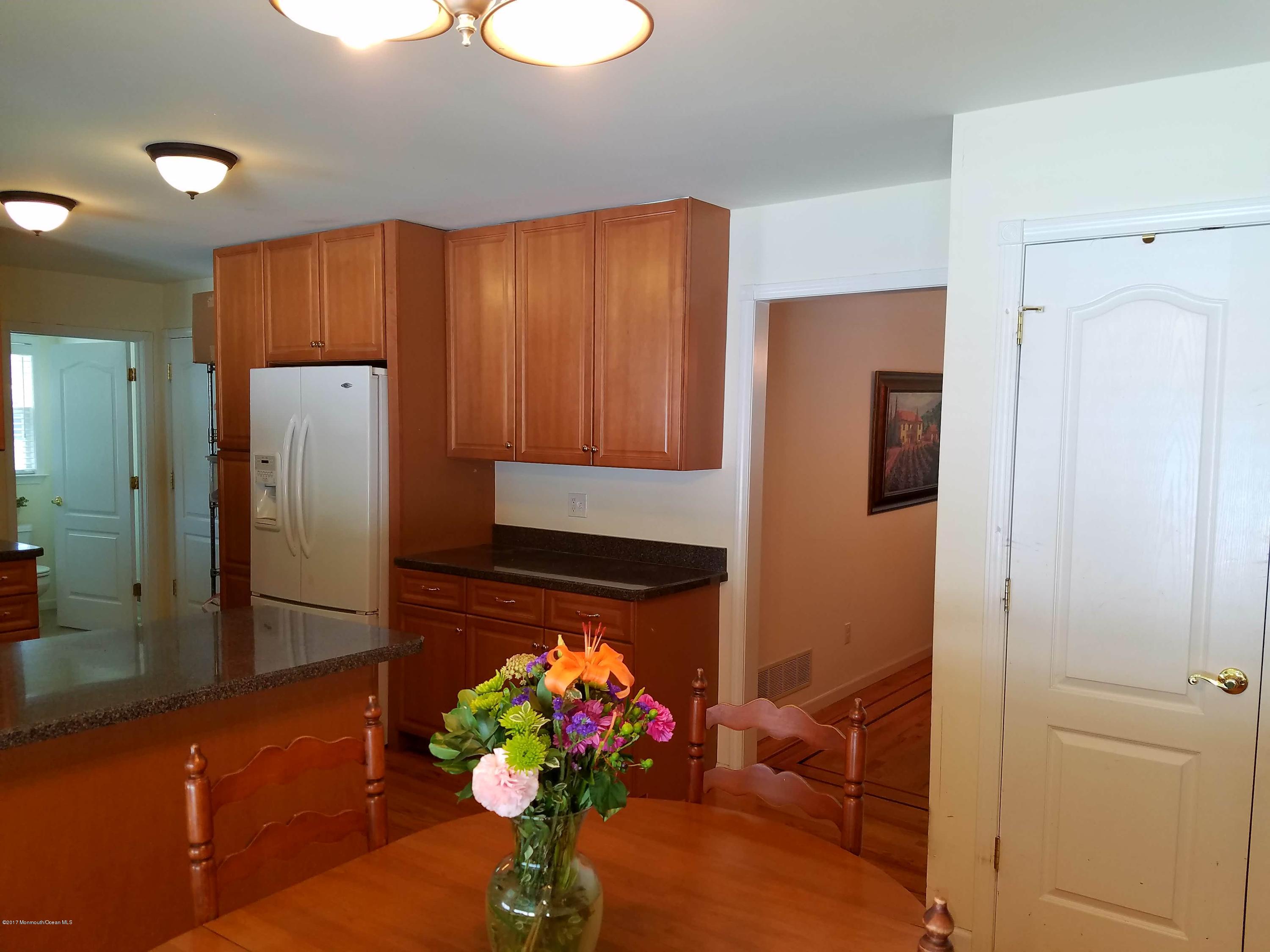 126 Robin Road Neptune Township, NJ 07753 - Photo 8 of 24 a living room with stainless steel appliances granite countertop a refrigerator and a potted plant