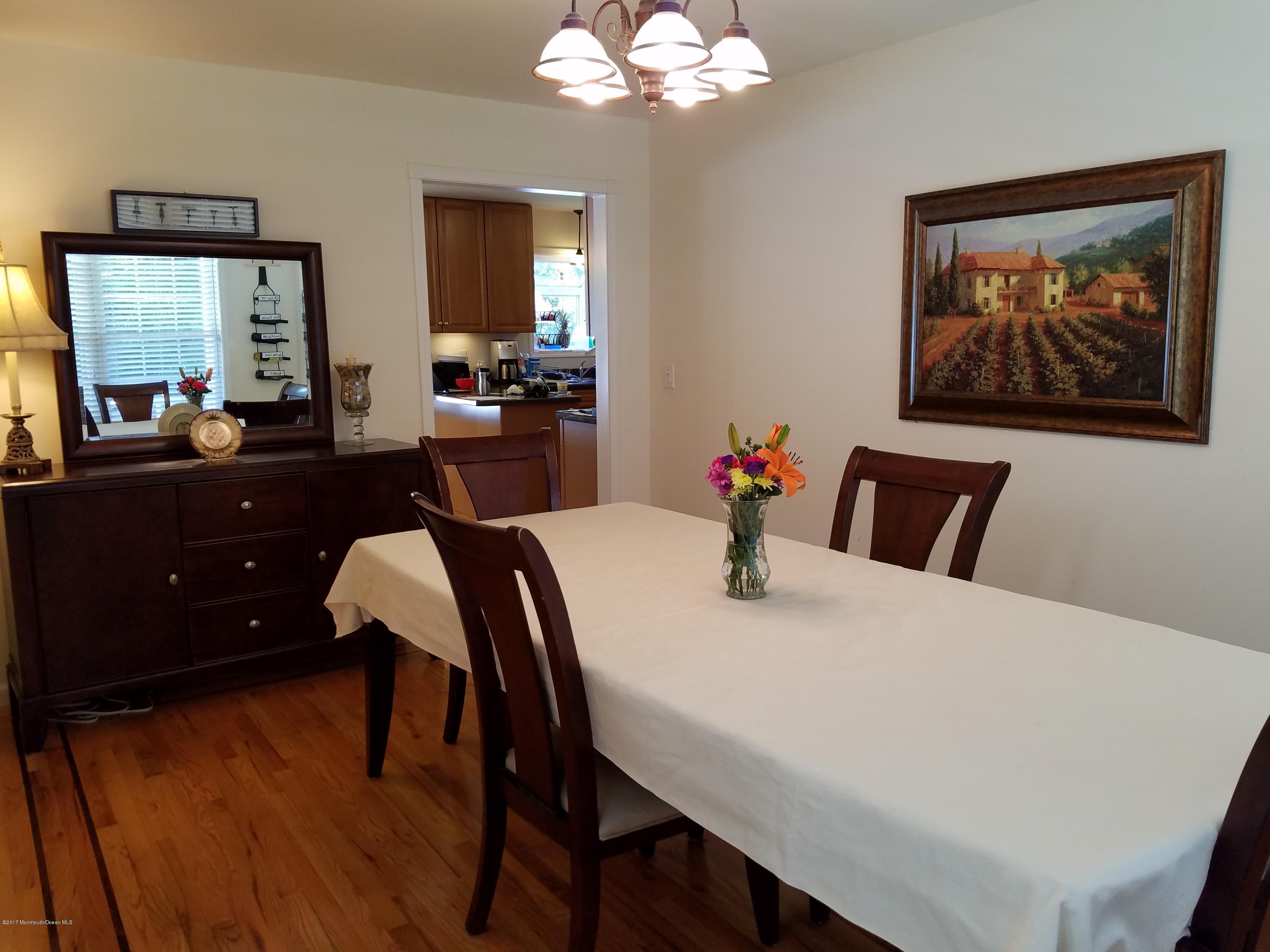 126 Robin Road Neptune Township, NJ 07753 - Photo 9 of 24 a view of a dining room with furniture and wooden floor