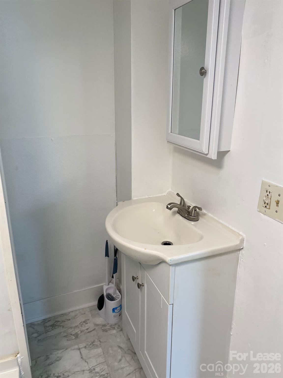 435 Davis Street Albemarle, NC 28001 - Photo 5 of 30 a bathroom with a sink and a mirror