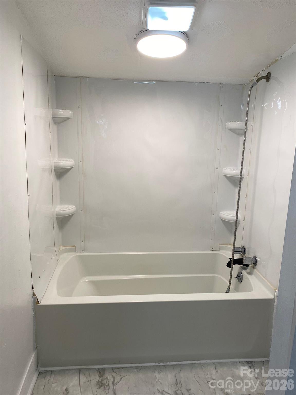 435 Davis Street Albemarle, NC 28001 - Photo 6 of 30 a bathroom with a bathtub and a shower