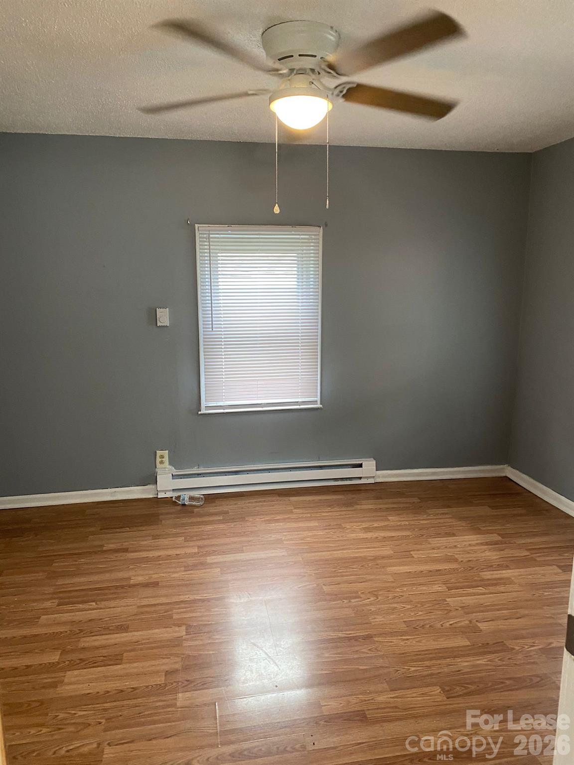 435 Davis Street Albemarle, NC 28001 - Photo 9 of 30 a view of an empty room with window and wooden floor