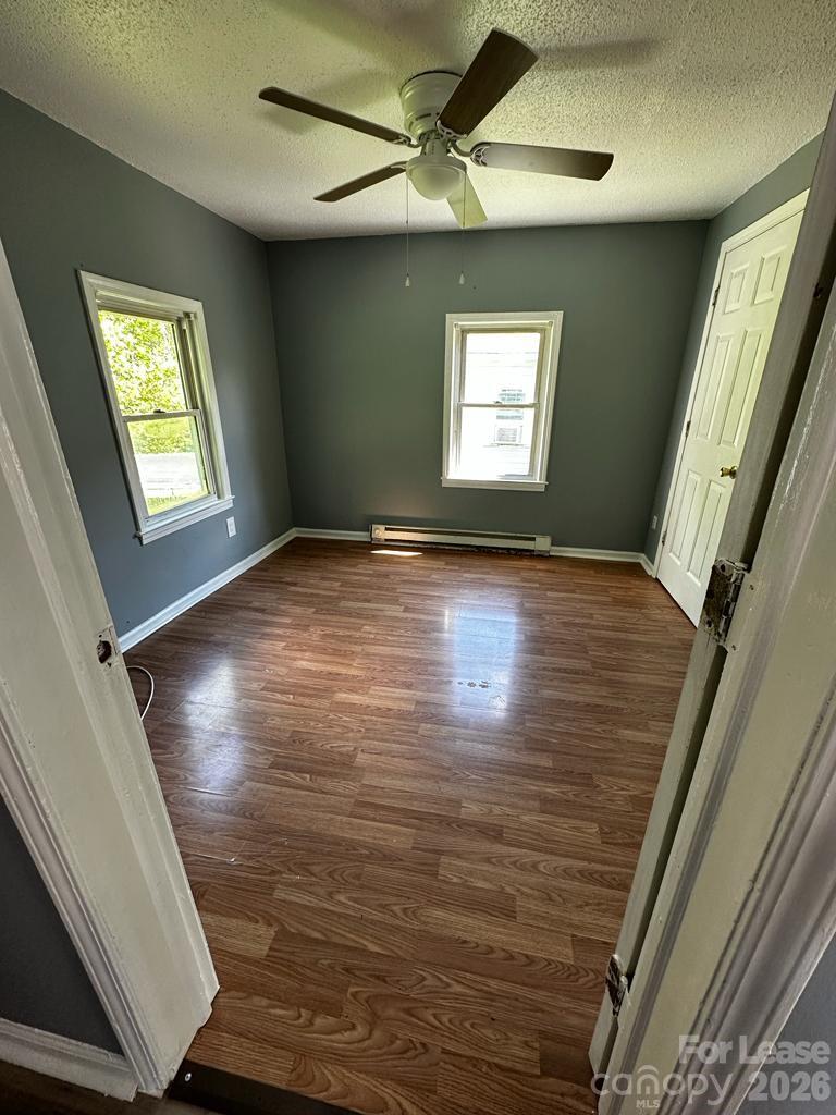 435 Davis Street Albemarle, NC 28001 - Photo 10 of 30 a view of an empty room with window and wooden floor
