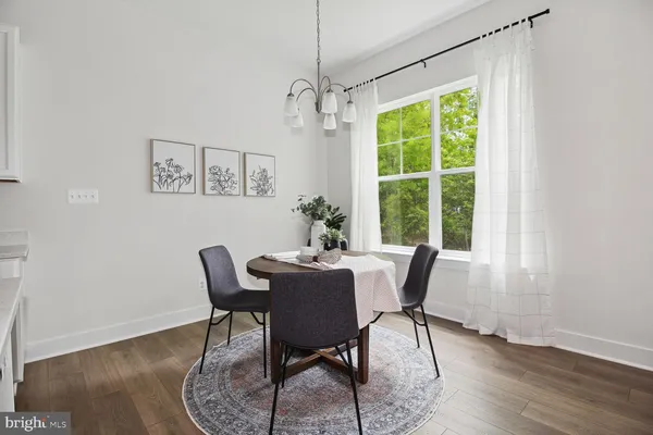 a kitchen that has a dining table and chairs in it