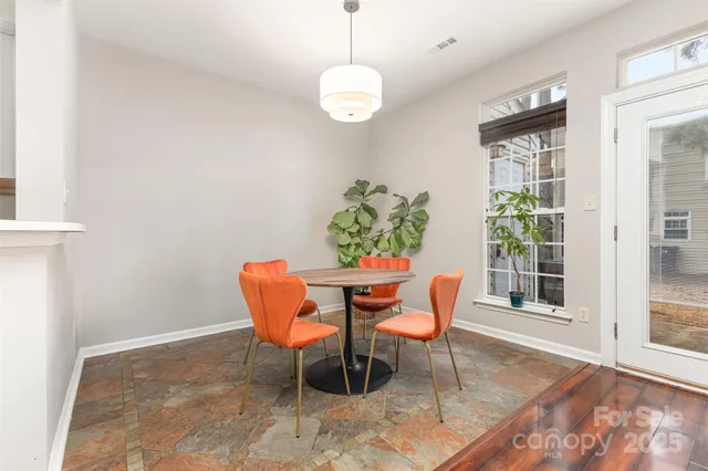 a dining room with furniture a rug and a window