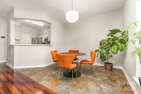 a view of a dining room with furniture and a potted plant