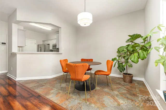a view of a dining room with furniture and a potted plant