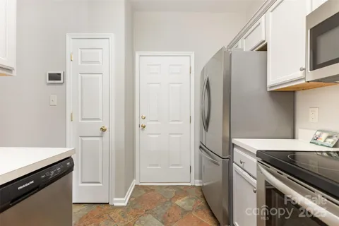 a kitchen with stainless steel appliances a refrigerator and a stove