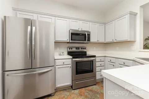 a kitchen with a refrigerator stove and microwave