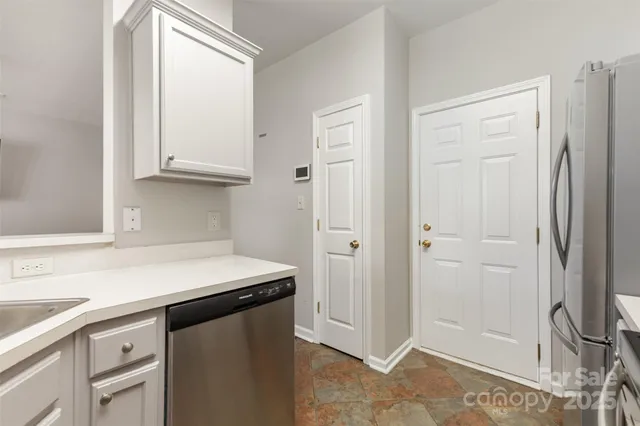 a kitchen with stainless steel appliances a refrigerator and cabinets