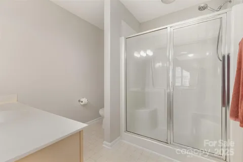 a bathroom with a glass shower door