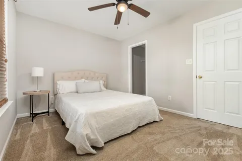 a bedroom with a bed and ceiling fan