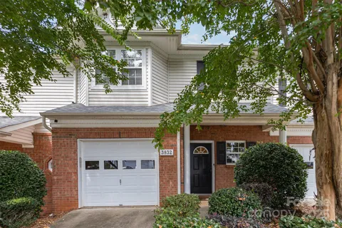 front view of a house with a tree