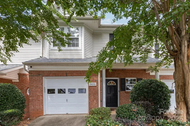 front view of a house with a tree