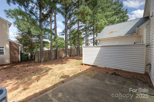 a view of a backyard with a tree