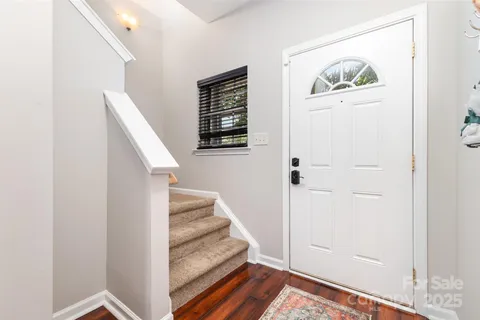a view of entryway with stairs and wooden floor