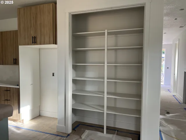 a view of an empty room with empty shelves