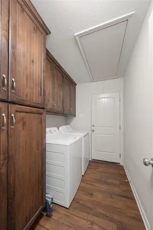 a view of a kitchen with cabinets and wooden floor